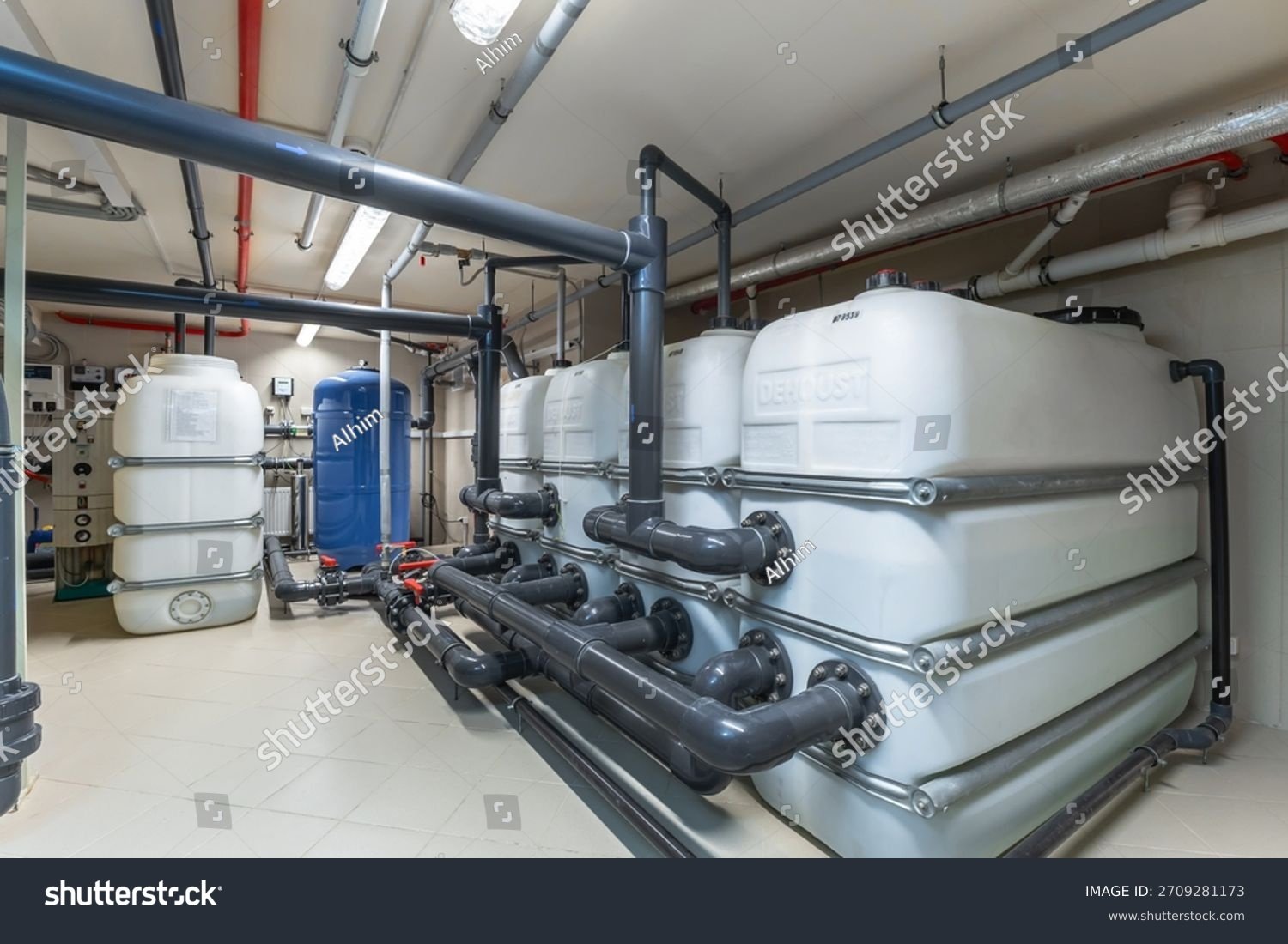 stock-photo-large-water-tanks-and-extensive-piping-are-organized-in-a-clean-utility-room-the-space-is-well-lit-2709281173
